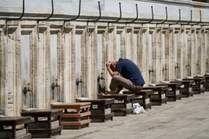 muslim man performing wudu to pray to Allah