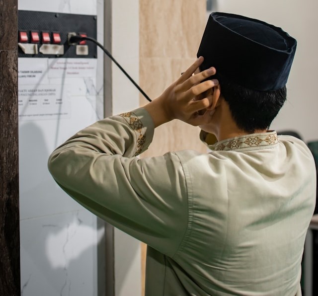 muslim imam performing the adhan the call to prayer