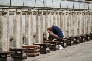 muslim man performing wudu at mosque