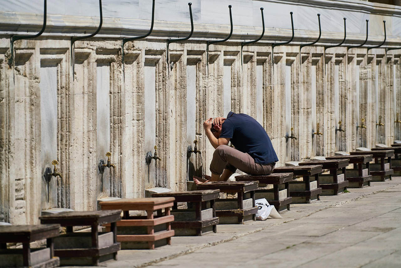 muslim man performing wudu at mosque